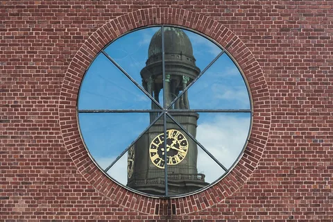 Reflection of St. Michaelis Church in a window of St. Ansgar in Hamburg, Germany.