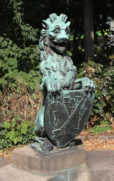 Bronze sculpture of a lion with armorial shield at Catholic parish church St. Ansgar and St. Bernhard in Hamburg