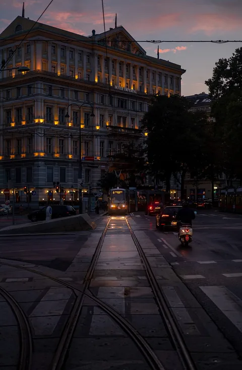 Tram in Kärntner Ring, near Hotel Imperial, at twilight, photograph taken from the back window of another tram (Vienna, Austria)