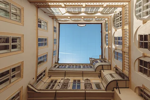 View up to the sky from the courtyard of the Bäckerstraße 7 in Vienna, Austria. The sky is framed by the building.