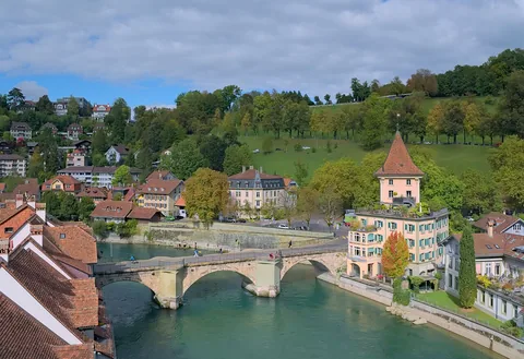 The Untertorbrücke crossing the Aare river in Bern, Switzerland, with the Felsenburg complex on the right and Rosengarten in the back.